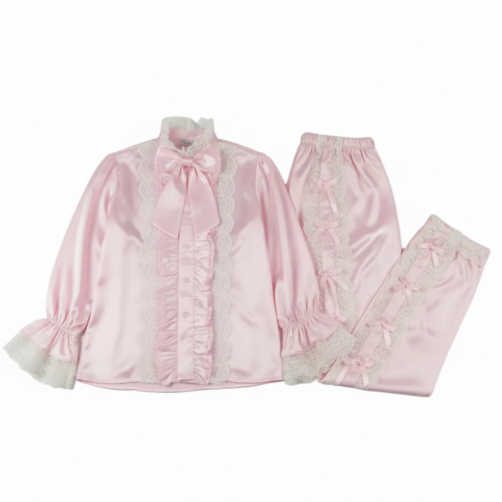 Pink satin pajama set with lace details on a white background