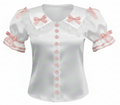 White satin blouse with pink trim and buttons on a white background