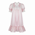 Pink nightgown with lace details on a white background