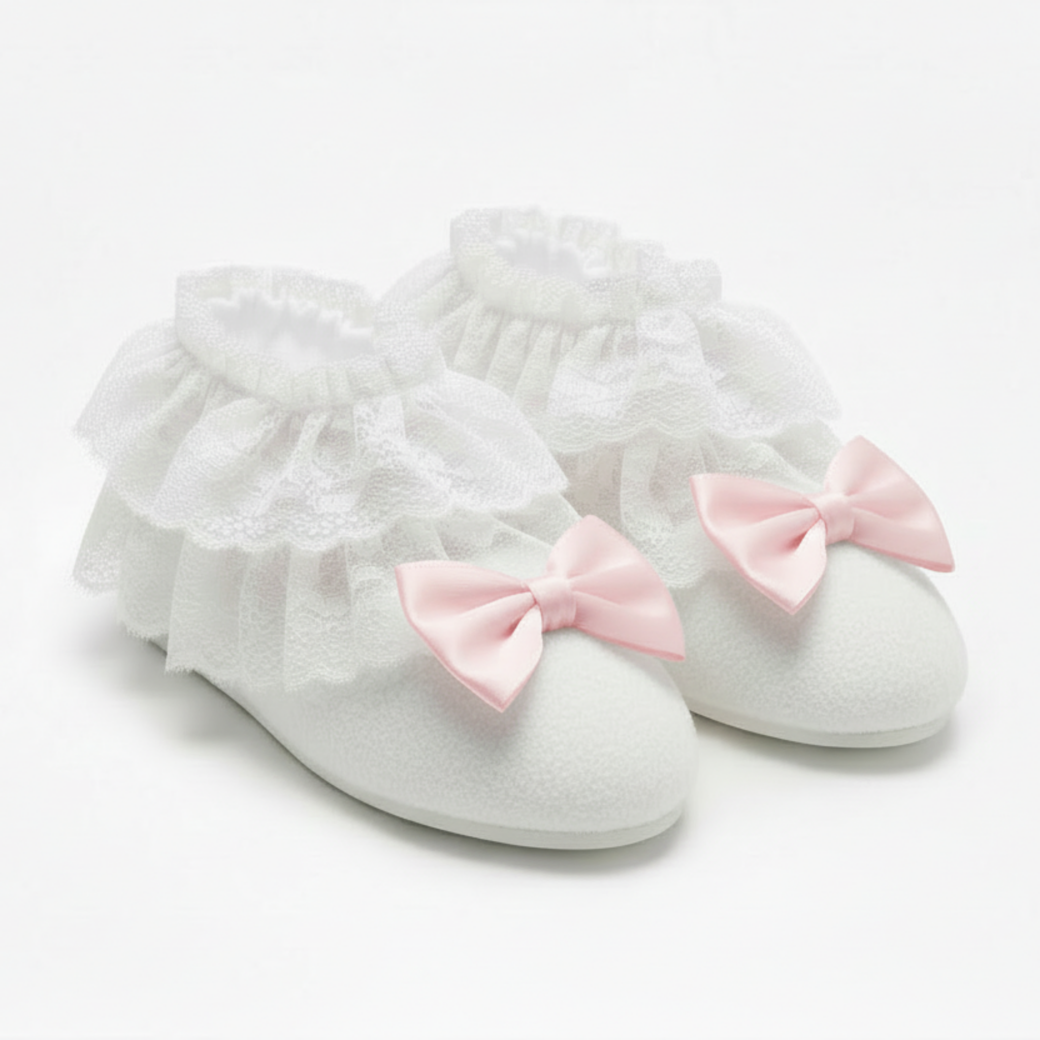 White booties with pink bows on a light gray background