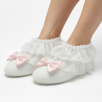 White slippers with pink bows on a white background