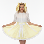 Woman wearing a white top and yellow skirt with a white belt on a white background